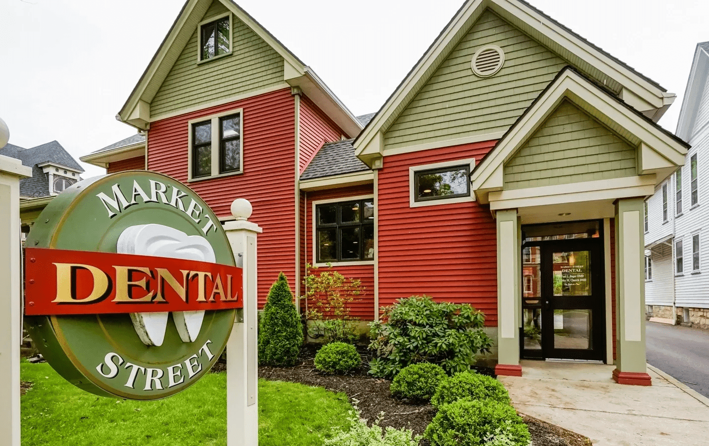 Red and green dental office building exterior.